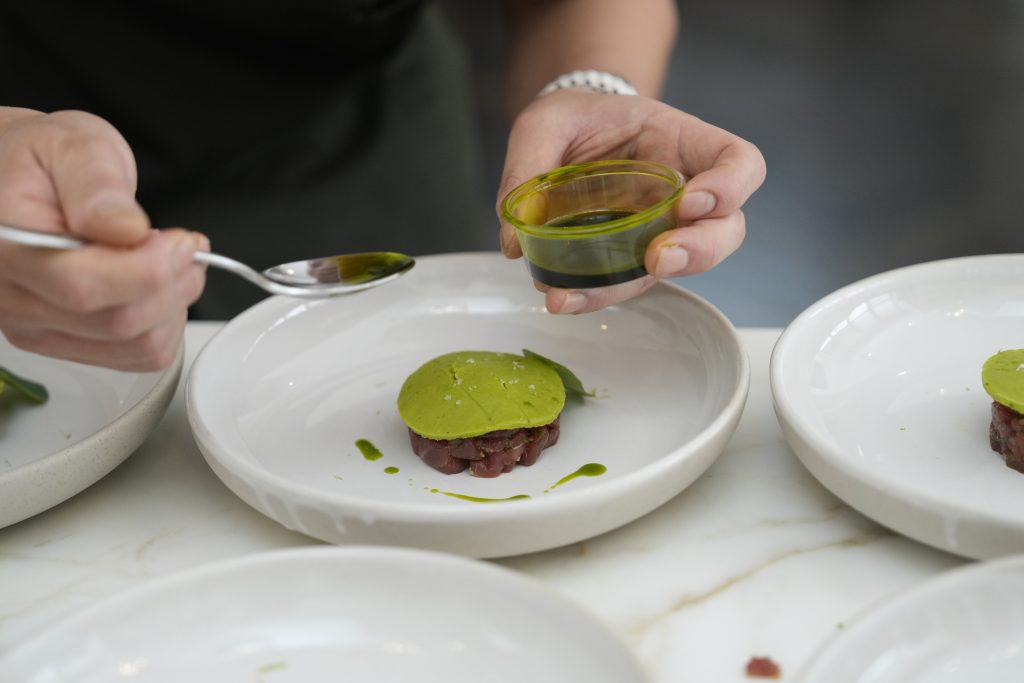 Chef Lyan Shim plating a dish – Refine Catering private dining Sydney